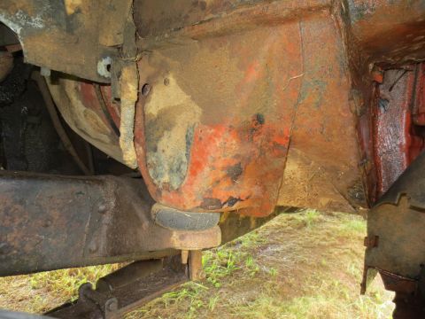 1967 Ford F-250 - Close-up view of heavily rusted frame and suspension parts on a truck.