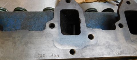 1968 Mercury Cougar - Close-up of an engine cylinder head showing stamped identification numbers and valve springs.