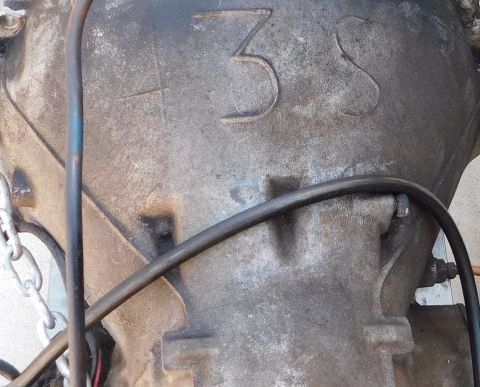 1968 Mercury Cougar - A close-up view of a transmission casing shows cast-in numbers and attached hoses.