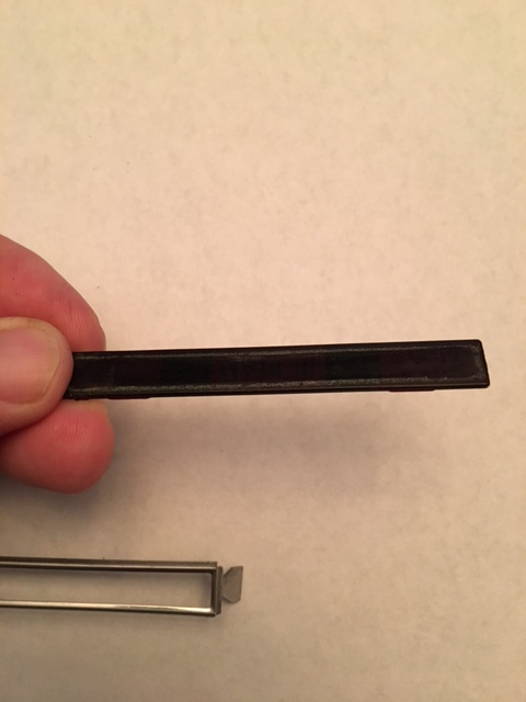 1968 Mercury Cougar - A close-up of a black trim piece and a metal frame, likely automotive parts.