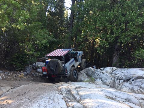 1979 Ford Bronco - This 1979 Ford Bronco navigates a challenging rocky trail with an American flag soft top.