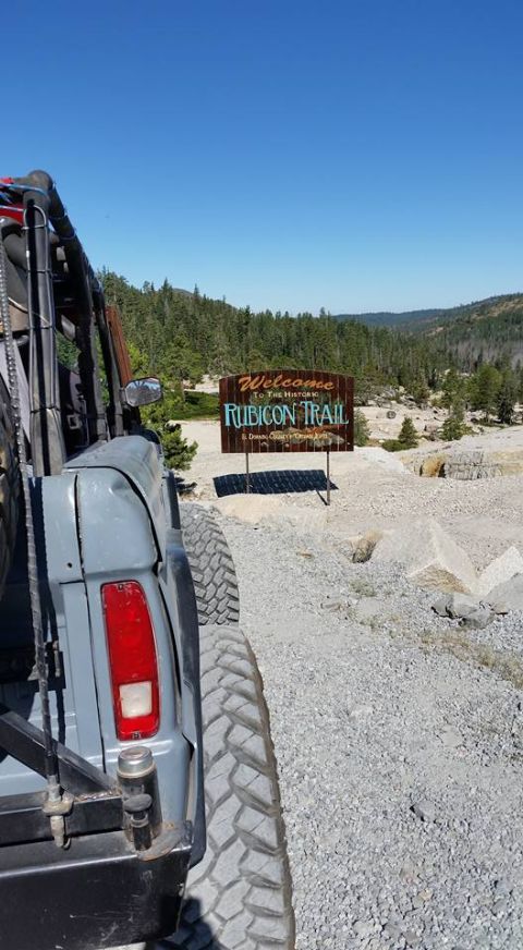 1979 Ford Bronco - A vehicle is parked by the entrance sign for the historic Rubicon Trail in a mountainous, wooded area.
