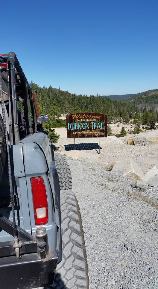Off-road vehicle parked near a sign for the Rubicon Trail