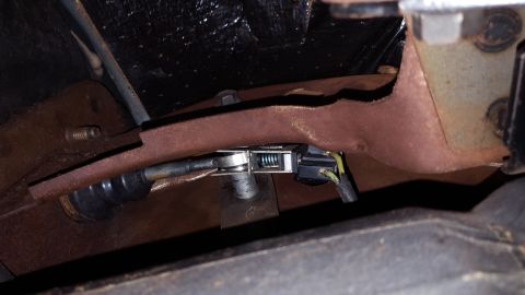 1971 Ford Mustang - This photo shows a close-up view of a vehicle's clutch linkage mechanism, including a spring and wiring.