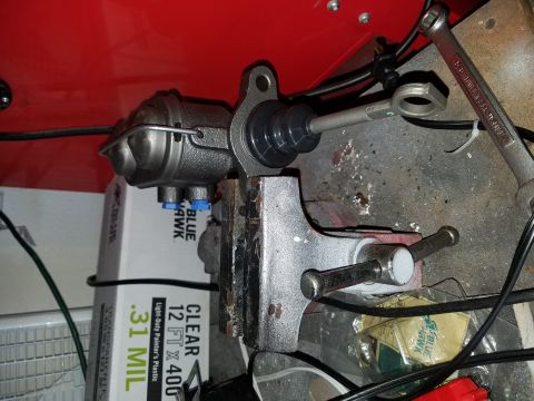 1971 Ford Mustang - Brake master cylinder held in a vise, ready for work. Painter's plastic and tools are also in view.