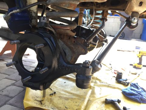 1978 Ford Bronco - Close-up of a vehicle's steering knuckle and suspension components, with a part number visible.