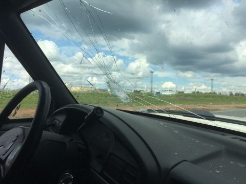 1993 Ford Bronco - The windshield is heavily cracked, obscuring the view of the landscape and sky beyond.