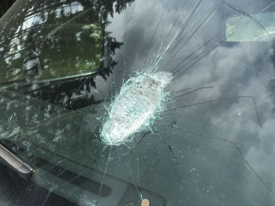 Cracked windshield with impact point, interior view
