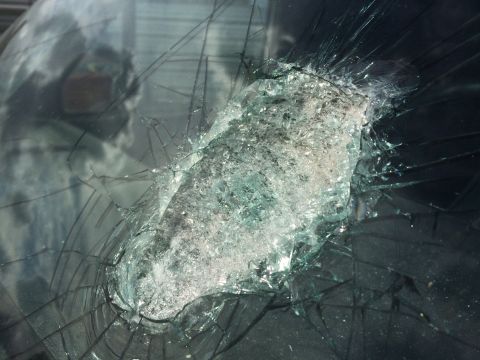 1993 Ford Bronco - Close-up of a severely damaged windshield, showing the extent of the impact and broken glass.