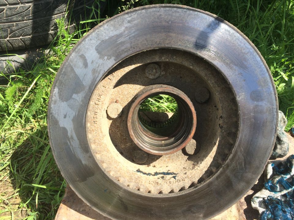 worn brake rotor with MIN THK 1.12 stamped on it