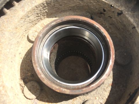 1993 Ford Bronco - A close-up view of a wheel hub assembly, showing rust and a clean bearing race.