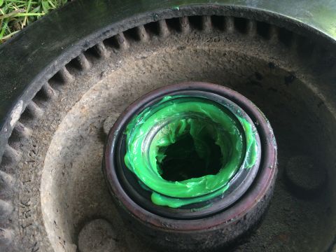 1993 Ford Bronco - Wheel bearing packed with green grease, part of a vehicle's braking system.
