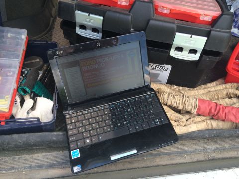 1993 Ford Bronco - A laptop displays information about Ford Pick-Ups and Broncos, with specific model years visible on the screen.