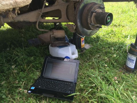 1993 Ford Bronco - A vehicle's brake system is shown with a laptop nearby, possibly for diagnostics.