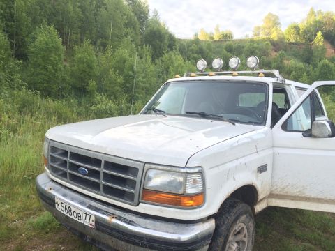 1993 Ford Bronco - This white Ford Bronco has a distinctive grille and body style, suggesting a 1992 model year.