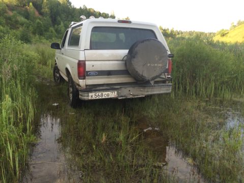 1993 Ford Bronco - This 1993 Ford Bronco is shown off-road in a wet, grassy area.