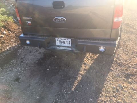 2004 Ford F-150 - The rear of a Ford F-150 pickup truck is shown with a Texas license plate and a custom bumper.