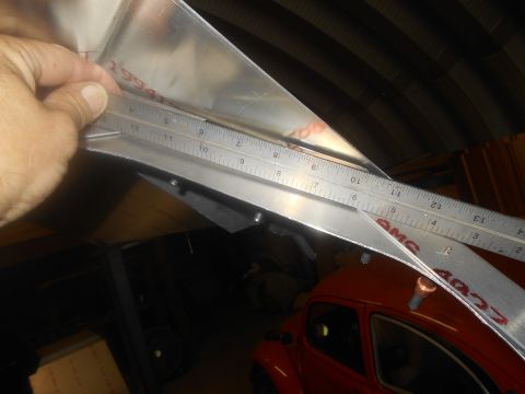 1992 Ford Bronco - A ruler measures a metal part, with the year 1994 visible on the part.