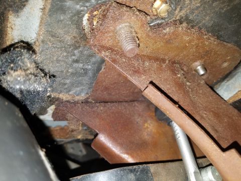 1971 Ford Mustang - Close-up view of a corroded metal bracket and bolt assembly, likely from a vehicle's interior or undercarriage.