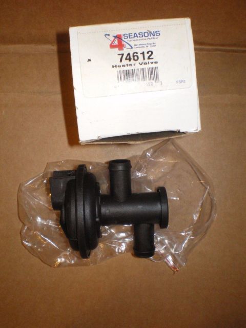 1967 Mercury Cougar - A new heater valve part is shown, still in its packaging, next to its original box.