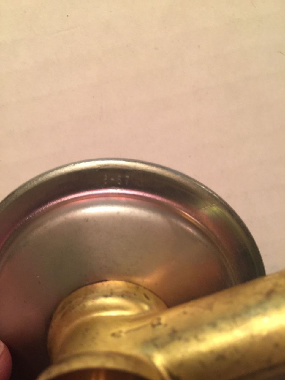Part with "8-67" stamped on it