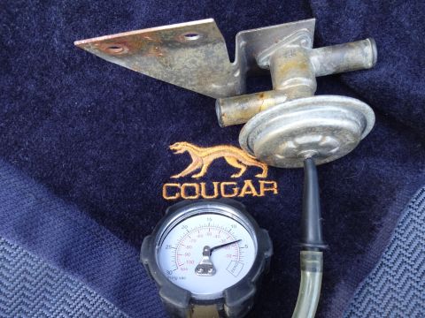 1967 Mercury Cougar - A vacuum diaphragm and gauge are shown with an embroidered Cougar logo on a dark fabric background.