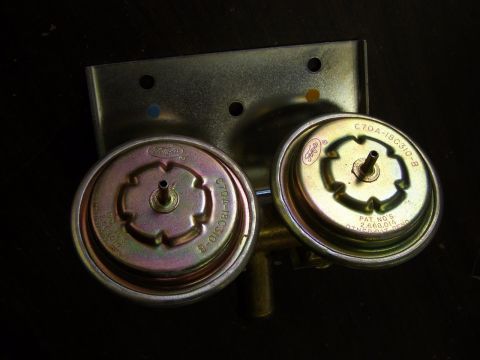 1967 Mercury Cougar - Pair of Ford vacuum actuators with visible part numbers and patent information.