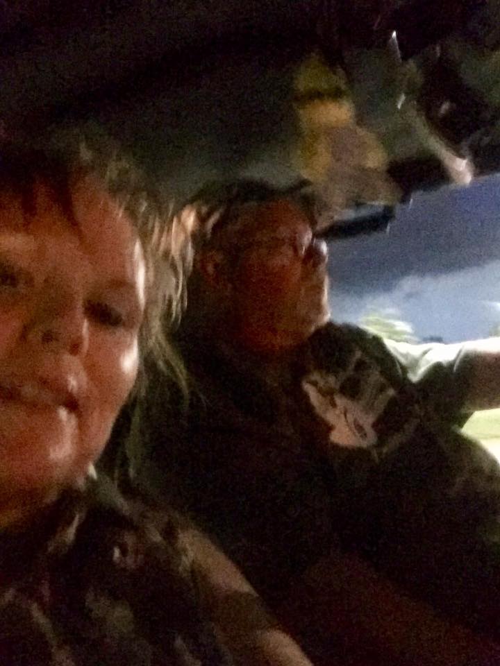 Two people inside a vehicle at night, with a 'SUPERMOTORS' watermark