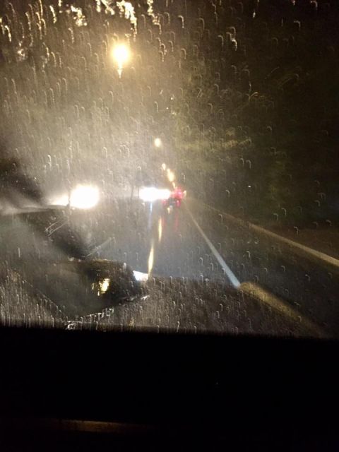 1972 Ford Bronco - Driving through heavy rain at night, visibility is poor due to water on the windshield.