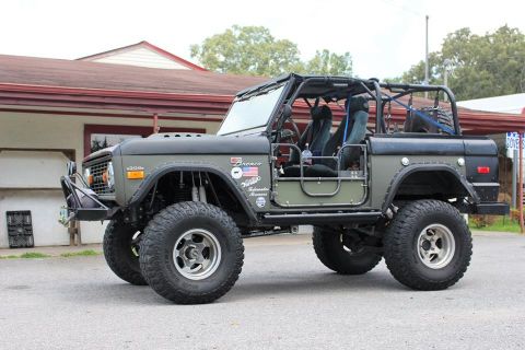 1972 Ford Bronco - Modified Ford Bronco with off-road modifications, viewed from a three-quarter front angle.
