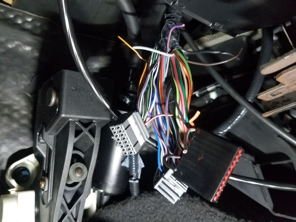Close-up of a car's interior wiring harness with many colorful wires and connectors