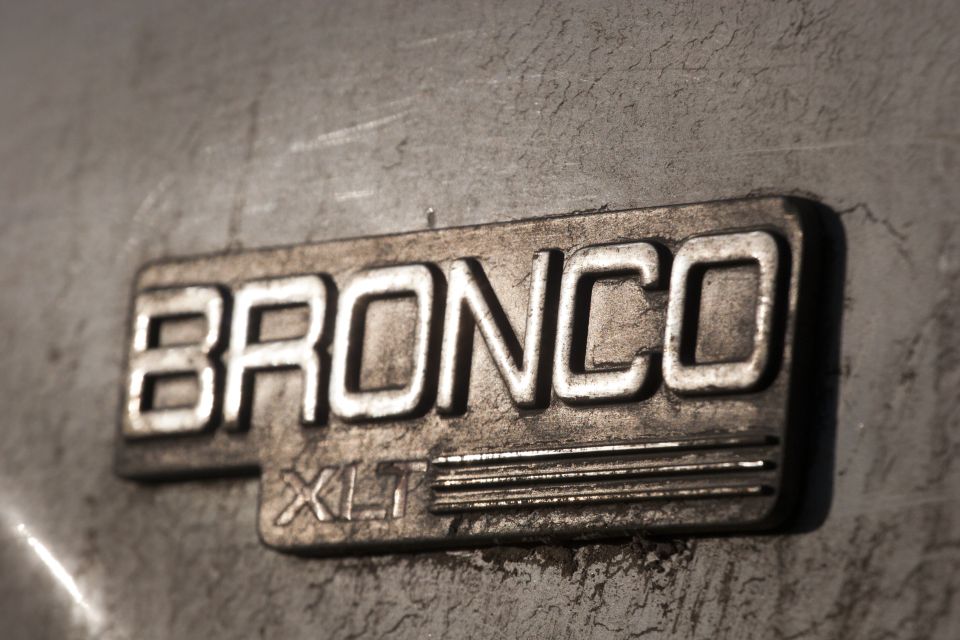 Close-up of Bronco XLT badge on a textured metallic surface.