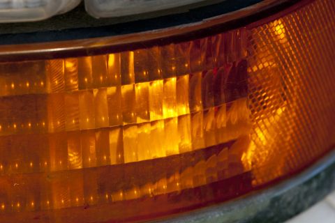 1993 Ford Bronco - A close-up shot shows the textured, amber plastic of a vehicle's turn signal or marker light. The light reflects the internal structure of…