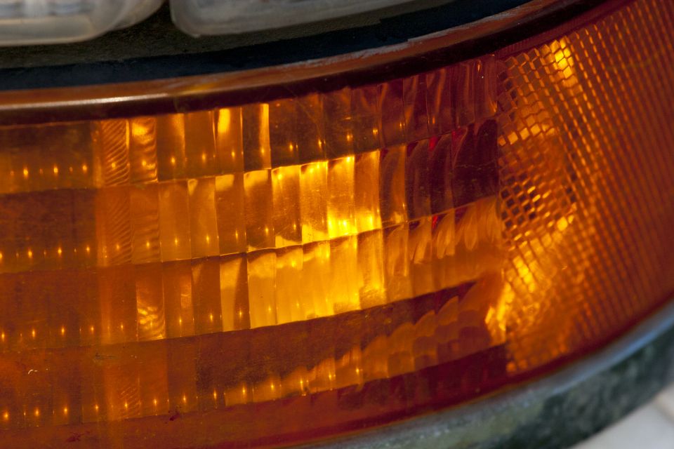 Close-up of an amber vehicle turn signal lens with textured pattern.