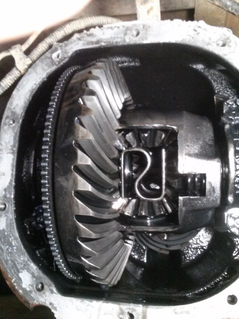 1996 Ford Bronco - A close-up view of the differential gears inside a vehicle's axle housing. The large ring gear is visible, along with the smaller pinion ge…