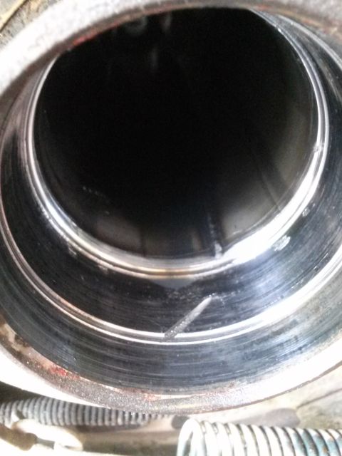 1996 Ford Bronco - This is a close-up, interior view of a metal bearing or race with visible scoring and wear marks. The outer edge shows some red staining an…