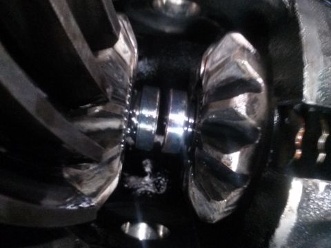1996 Ford Bronco - Close-up view of a differential with two beveled gears meshing. The gears appear to be made of metal and have a polished finish.