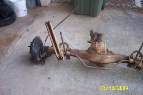 1979 Ford F-150 - A rusty rear axle assembly, likely from a truck, is shown resting on a concrete surface.