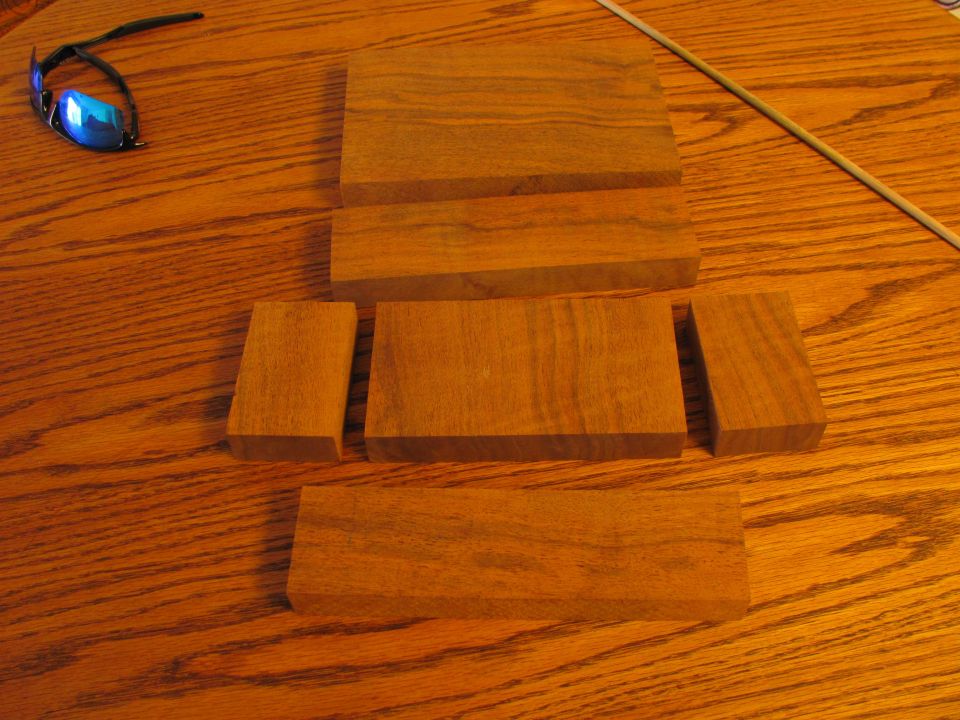Blue mirrored sunglasses on a wooden table with wood pieces.