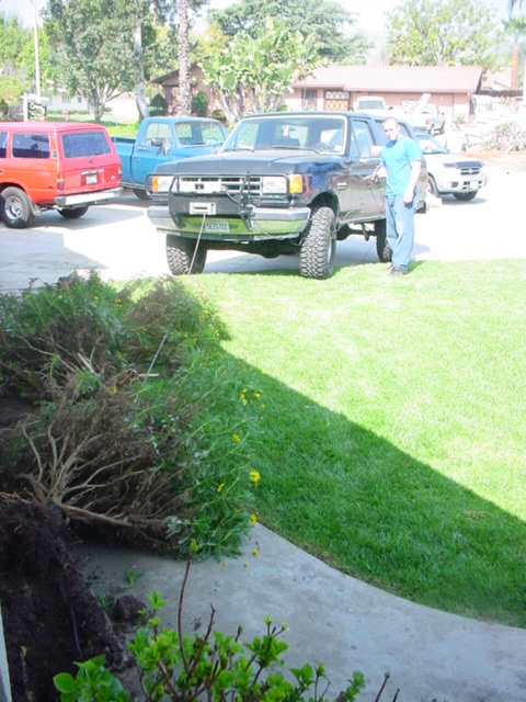 1988 Ford Bronco - A 1988 Ford Bronco is parked in a residential driveway, with a man standing next to it.