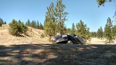 1995 Ford Bronco - 1995 Ford Bronco captured in motion on an off-road trail.