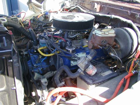 1979 Ford Bronco - Close-up view of a vehicle's engine compartment, showing various components and wiring.
