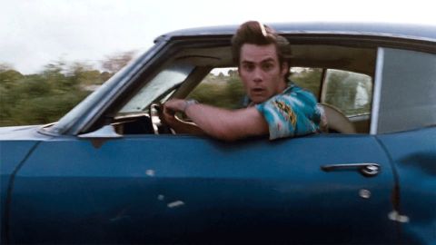 1995 Mercury Grand Marquis - Movie screen grab used as a reaction image: a wide-eyed man in a bright floral shirt leans out the driver's window of a moving blue two-doo…