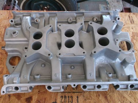 1963 Ford Galaxie - An aluminum intake manifold is shown, likely a performance part, with visible casting marks and numbers.