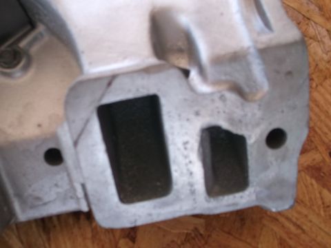 1963 Ford Galaxie - This is a close-up view of a metal engine intake manifold, showing its ports and casting marks.