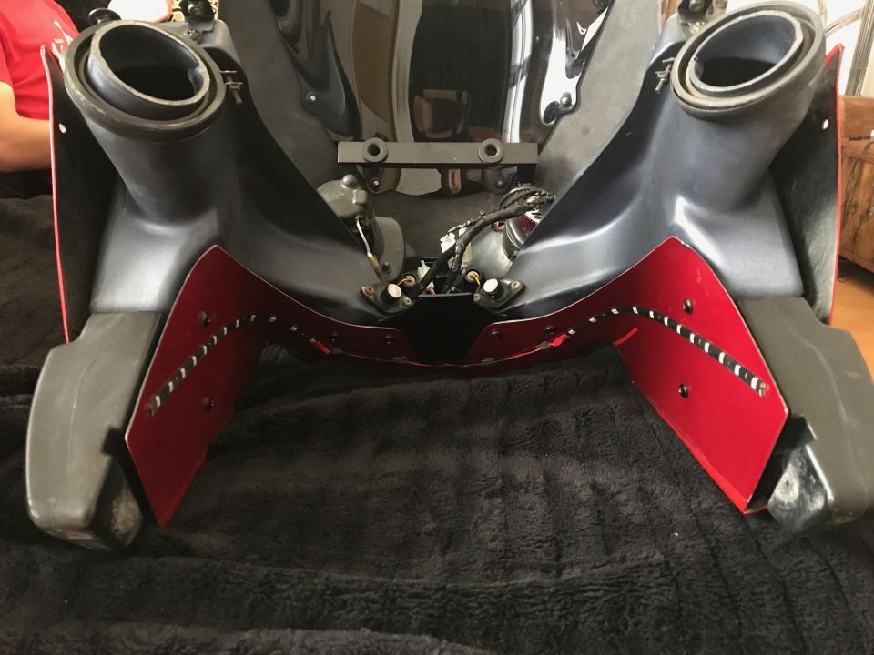 Red and black bumper or fairing component with dual ducts and rivets
