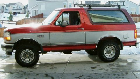 1996 Ford Bronco - This two-tone Ford Bronco is shown from the side, equipped with a roof rack.