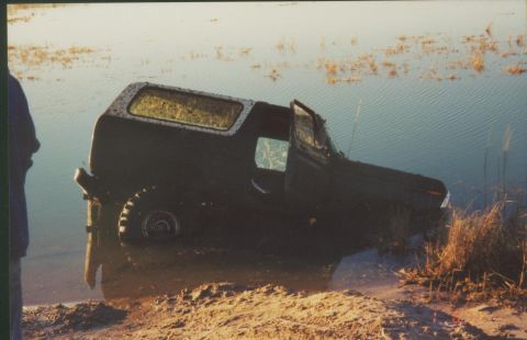 1993 Ford Bronco - This 1993 Ford Bronco is stuck in the water with its doors open.