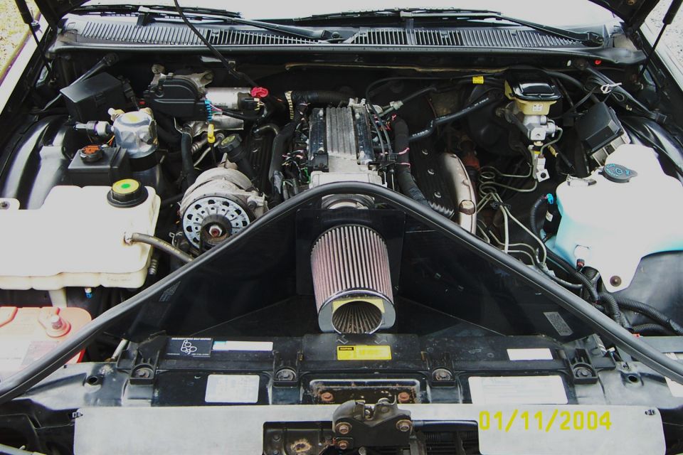 Engine bay with chrome cone air intake filter and black intake tube