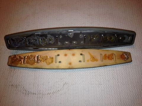 1968 Mercury Cougar - Disassembled car trim pieces showing adhesive residue on both parts.